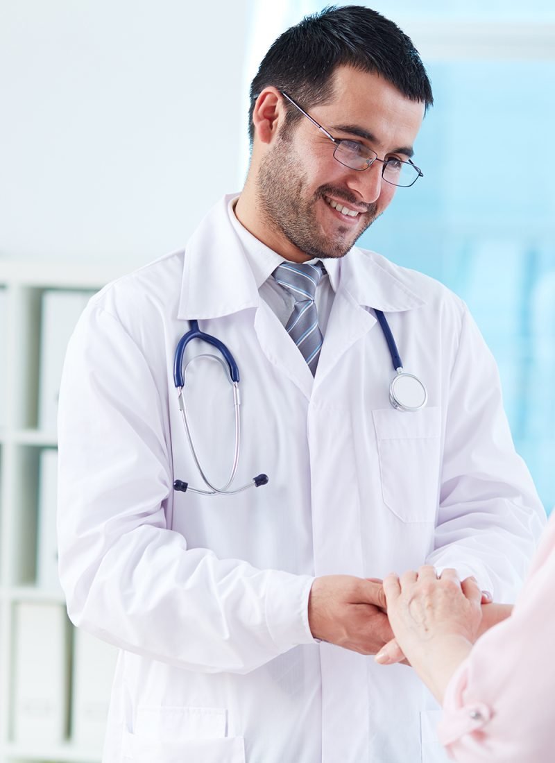 Speaking with patient Confident doctor looking at his senior patient while speaking to her